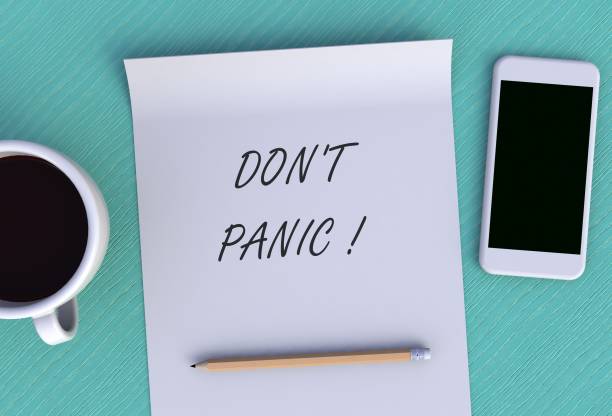istock DON'T PANIC, message on paper, smart phone and coffee on table, 3D rendering 1145223524