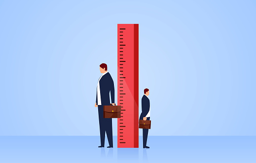 Measuring, two businessmen stand sideways on both sides of the ruler