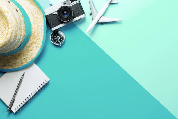 istock Summer travel accessories with compass on phone on blue green copy space 1145226138