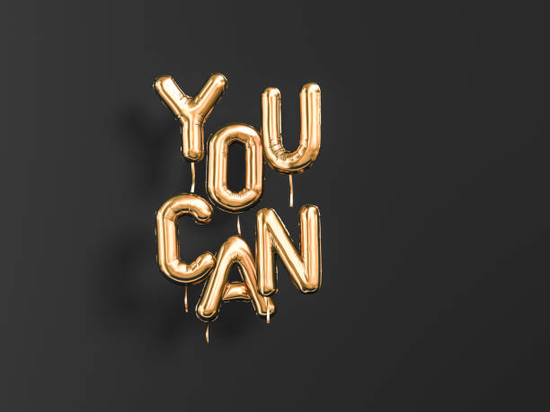 istock You Can gold text sign letters isolated on black. 1145226344