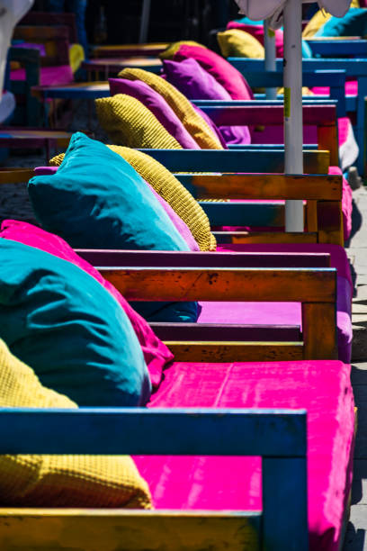 istock Colorful pillows on wooden sofa. Exterior design concept. 1145228436