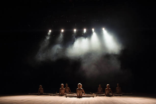 istock Pretty young girl sitting on stage having stretching and training for ballet dances. 1145230957