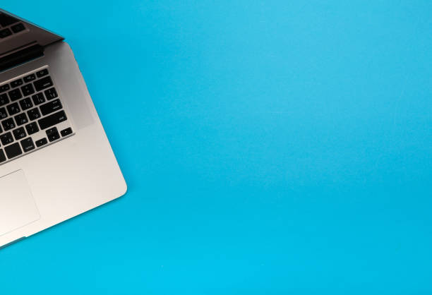 istock laptop on blue background flat lay place - Image 1145231611