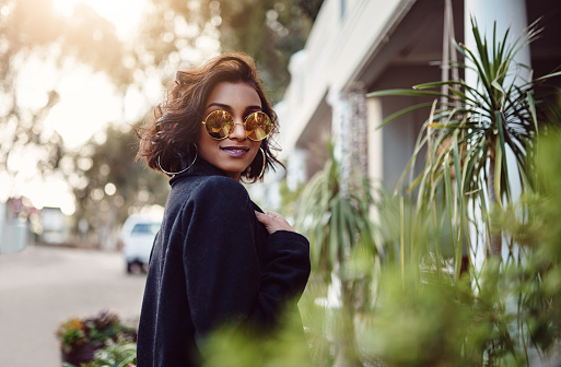 Shot of a fashionably dressed woman standing outside