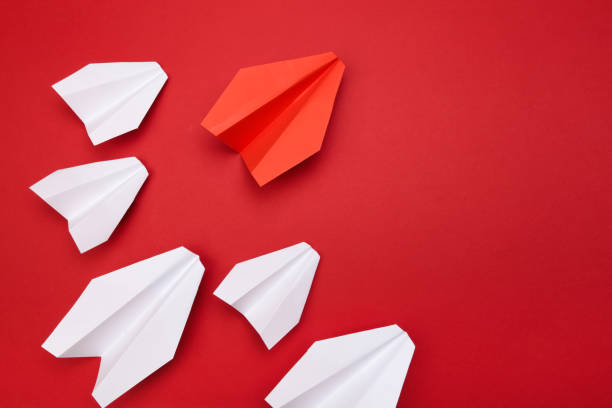 istock winner red  paper aircraft on red background - Image 1145231719