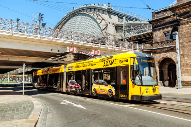 modern tram covered with advertisement in dresden near central station bahnhof - travel destinations outdoors tourist uk imagens e fotografias de stock