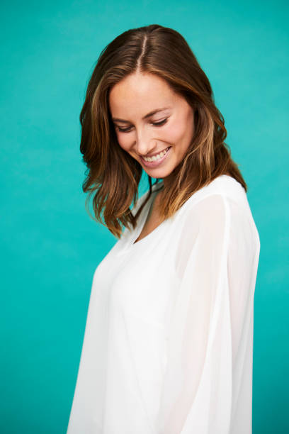 istock Smiling brunette in white top 1145236727