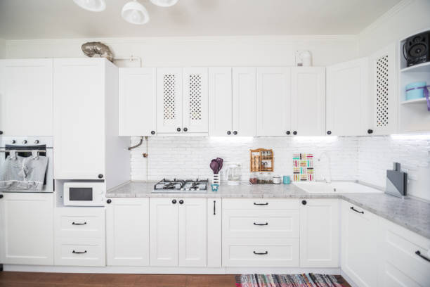 istock Modern white kitchen, gas stove with electric oven, clean design. Kitchen interiors 1145237513