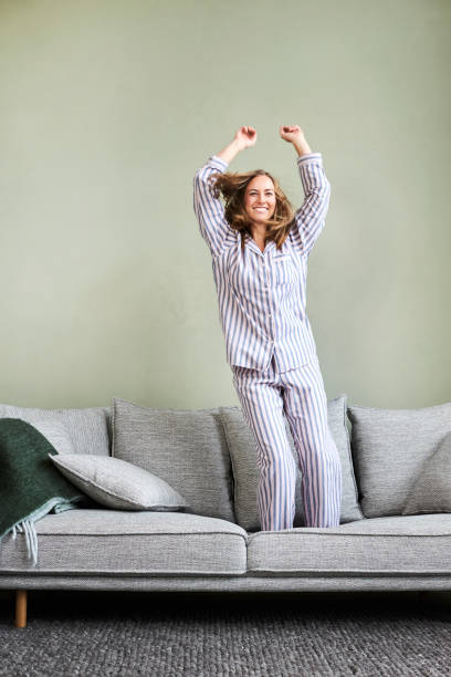 istock Jumping girl on sofa 1145237540