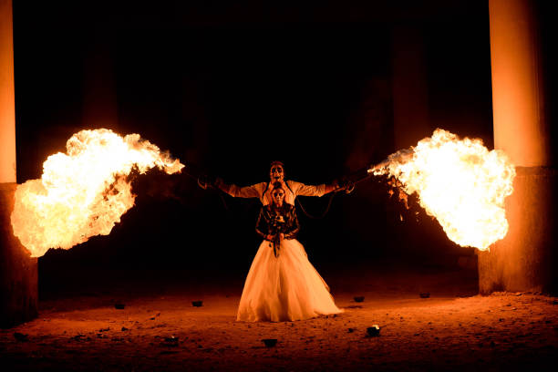 istock Halloween couple standing with flamethrower in hands. big fire 1145239827