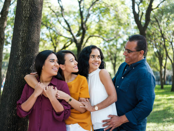 istock Father looking at wife and daughters while smiling 1145241081