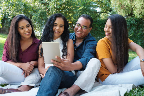 istock Father looking at a tablet with family 1145241097