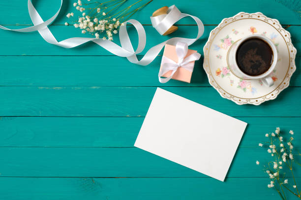 Wedding morning concept. Invitation card, gift box, cup of coffee, daisy flowers. Stylish minimal women's desk. Flat lay composition, top view, overhead. Wedding morning concept. Invitation card, gift box, cup of coffee, daisy flowers. Stylish minimal women's desk. Flat lay composition, top view, overhead white shabby chic desk stock pictures, royalty-free photos & images