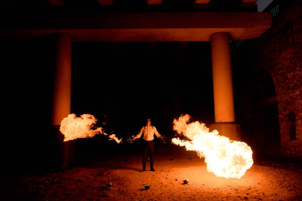 istock Halloween man in costume with flamethrower in his hands. Devil makeup on face 1145241596