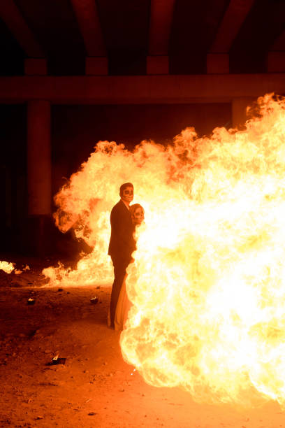 istock Halloween couple standing with flamethrower. big fire 1145241609