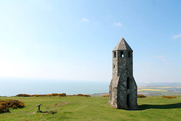 View of St Catherine's Oratory overlooking the sea and blue sky on the Isle of Wight, UK. Remnants of old church known locally as 'the spaceship' and 'the pepper pot' due to it's shape.