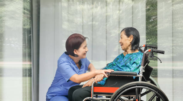istock elderly woman happiness talking with caregiver 1145247108