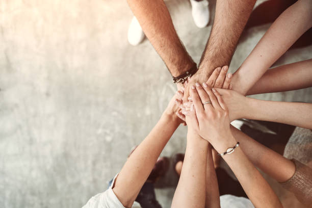 istock Group of friends stack their hands together, teamwork concept 1145247857