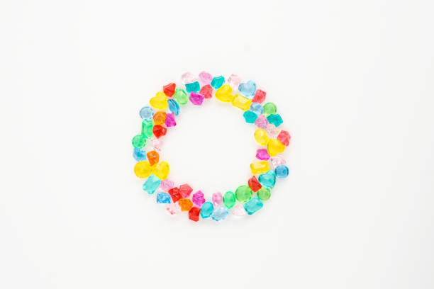 istock A scattering of many small different gems on a white background. Different shapes. Multicolor. Glasses collected in the ring. 1145249057