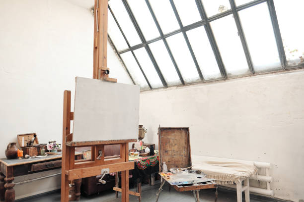 istock Bright art studio with a large window. Easels and canvases. 1145251255