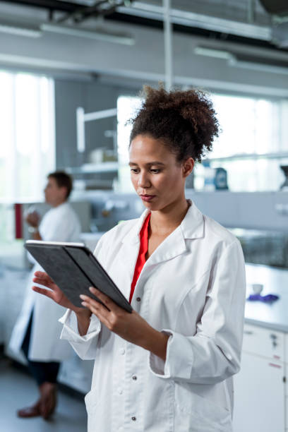 istock Young African American woman using a digital tablet in the laboratory 1145252917