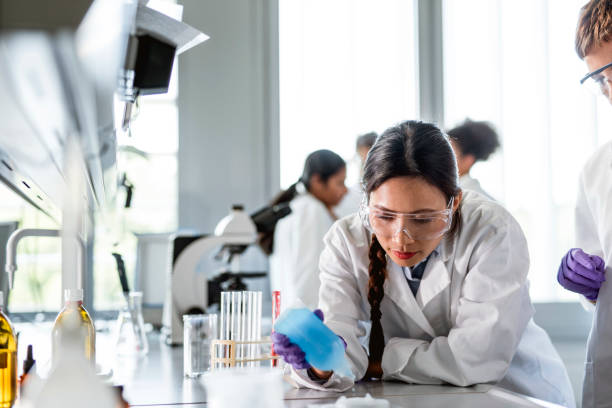 istock Asian woman working in the laboratory and using a microscope 1145252924