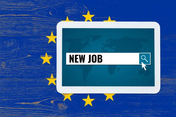 new job search in digital tablet over european union wood painted flag