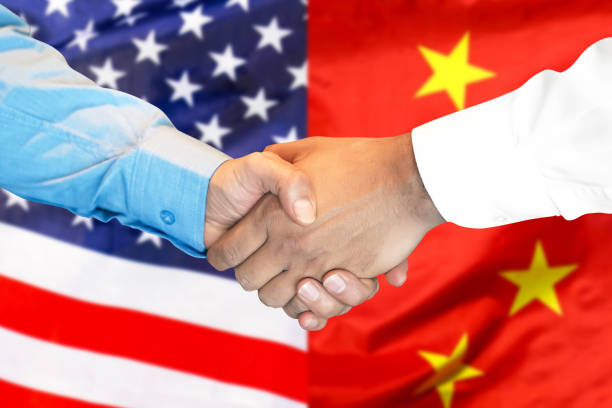 istock handshake on american and Chinese flag background. 1145254151