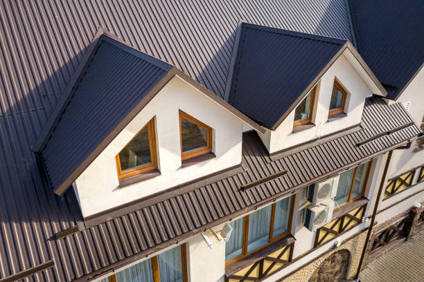 Close-up aerial view of building attic rooms exterior on metal shingle roof, stucco walls and plastic windows. Close-up aerial view of building attic rooms exterior on metal shingle roof, stucco walls and plastic windows. metal stock pictures, royalty-free photos & images