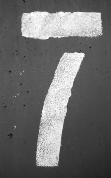 istock Number 7 in stencil on metal wall in black and white. 1145257530