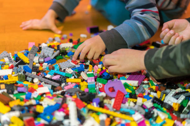 istock Close up of colorful plastic bricks on the floor. Early learning. Children's plastic constructor on the floor. Children's hands play a little constructor. 1145260889