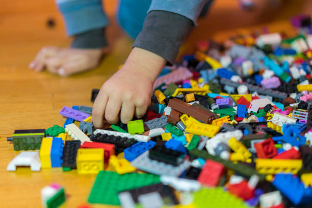 istock Close up of colorful plastic bricks on the floor. Early learning. Children's plastic constructor on the floor. Children's hands play a little constructor. 1145261706