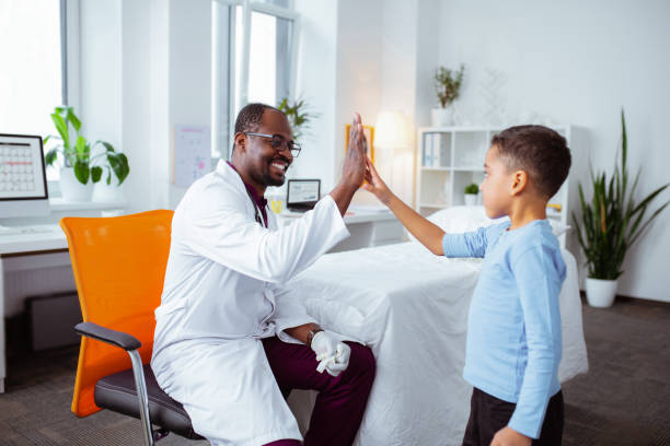 istock Cute boy giving high five to pleasant professional pediatrician 1145261947