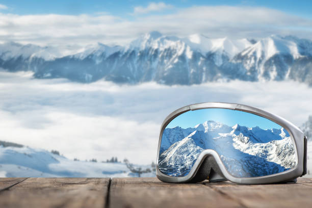 Ski goggles with reflection of mountains. stock photo