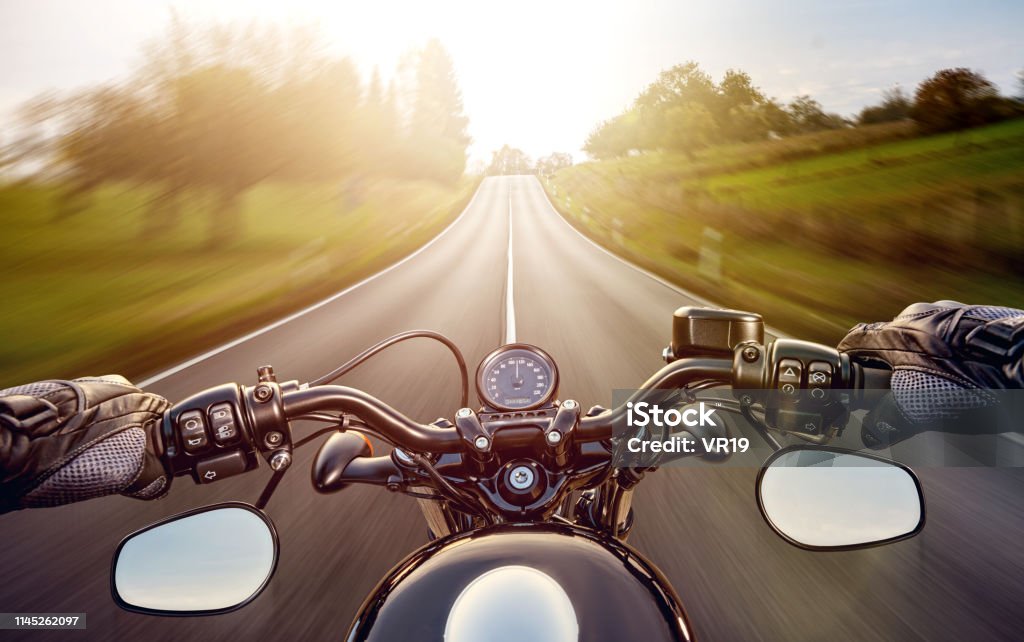 POV strzał młodego człowieka jazdy na motocyklu. Ręce motocyklisty na ulicy - Zbiór zdjęć royalty-free (Motocykl)