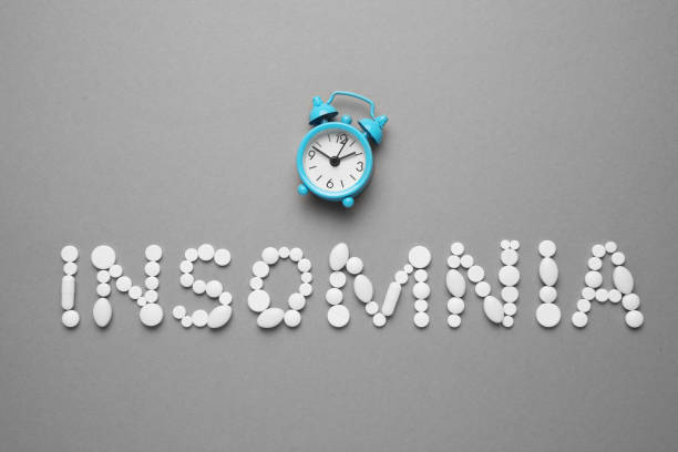 istock Sleeping pills and an alarm clock, insomnia concept. Night depression, anxiety 1145262100