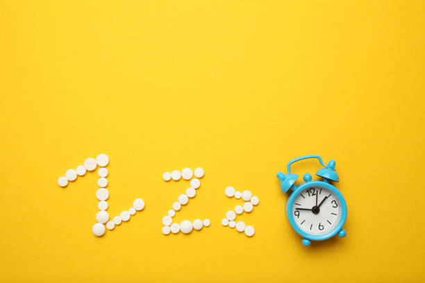 istock Sleeping pills and an alarm clock, insomnia concept. Nightmares and sleep disturbance 1145262101