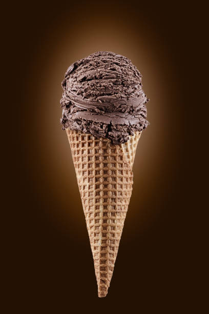 istock chocolate ice cream with cone over brown background 1145262338