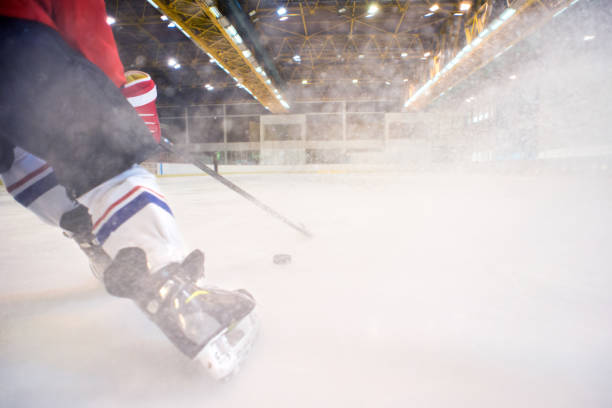 Ice hockey players playing ice hockey Ice hockey players playing ice hockey in the ice rink. hockey skates stock pictures, royalty-free photos & images