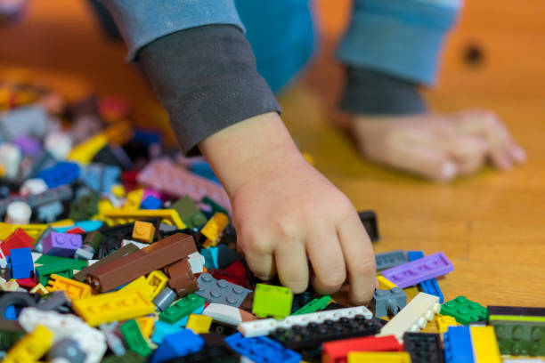 istock Close up of colorful plastic bricks on the floor. Early learning. Children's plastic constructor on the floor. Children's hands play a little constructor. 1145262509
