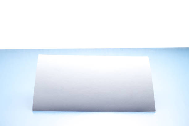 istock One blank white postcard / flyer / invitation mock-up on white and blue backgrounds 1145263103