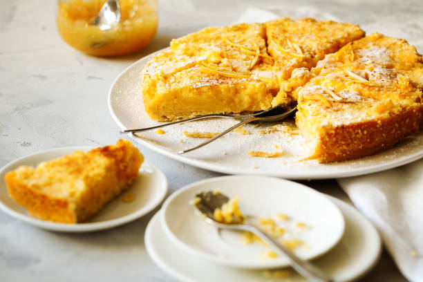 istock Traditional English lemon pudding cake with lemon twist and powdered sugar on a white plate on a light background. Homemade fruit pastries for the holiday dinner table 1145266202