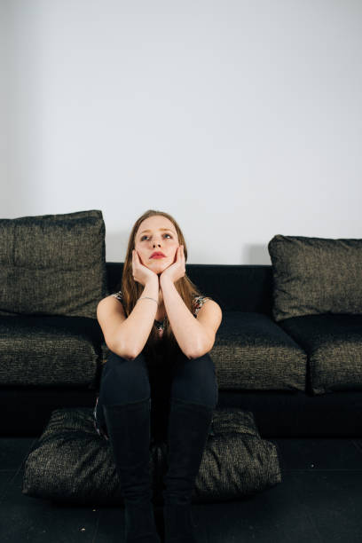 istock Alone and anxious young woman at home 1145266522