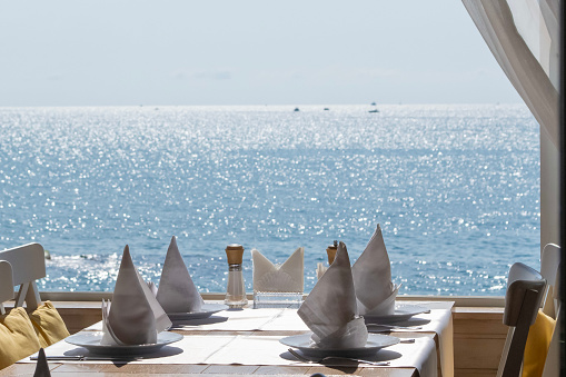Restaurant with beautiful view from open window on the sea.