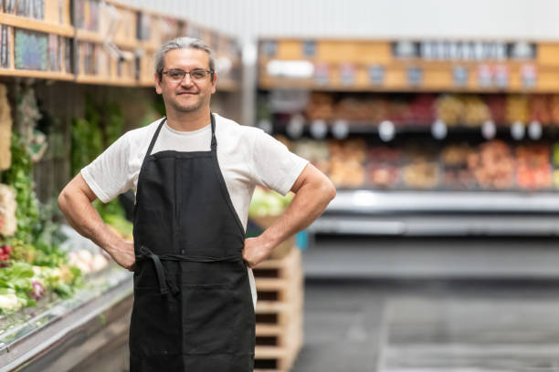 istock Mature man working at a supermarket vegetables and fruit section 1145269098
