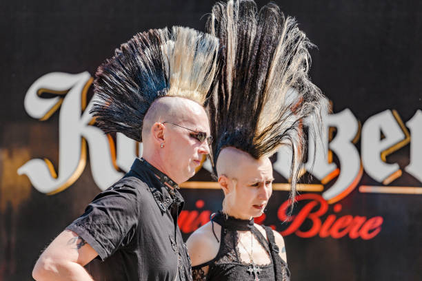 Expressive punk metalhead with a haircut Iroquois at the Annual Leipzig festival Leipzig, Germany - May 21, 2018:  Expressive punk metalhead with a haircut Iroquois at the Annual Leipzig festival emo hair guys stock pictures, royalty-free photos & images