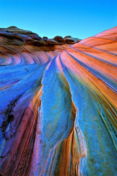 The Wave with Sandstone Prism 5 (variant) Phenomenon Coyote Buttes Vermilion Cliffs National Monument Arizona USA The Wave at Coyote Buttes area Vermilion Cliffs National Monument with "Sandstone Prism 5" phenomenon.  After rain water and quartz in sandstone together bend light like an opal gemstone.  Creating the colors of a rainbow or prism.  Arizona Utah border area USA.  Variant.  I named the phenomenon as no one else seems to have seen it.  Geologist explained to me what was going on. rock formations stock pictures, royalty-free photos & images