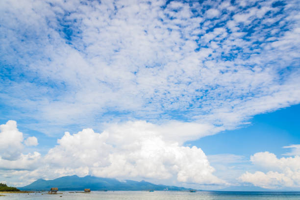 beautiful cloud patterns scattered in the skies over the beautiful blue sea.