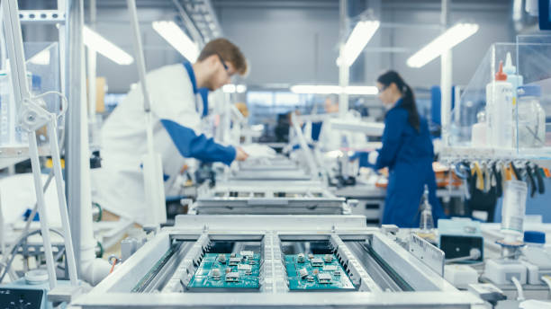 istock Shot of an Electronics Factory Workers Assembling Circuit Boards by Hand While it Stands on the Assembly Line. High Tech Factory Facility. 1145276201
