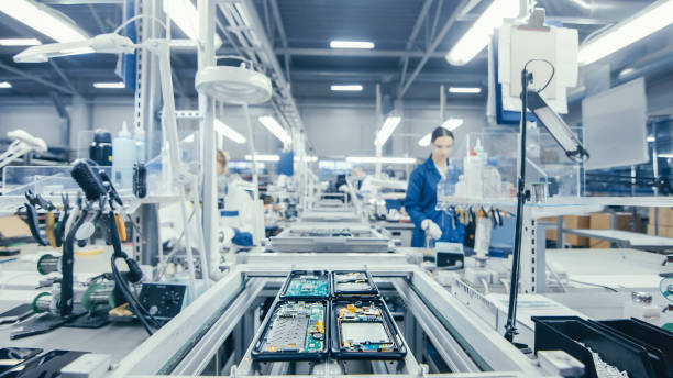 istock Shot of an Electronics Factory Workers Assembling Circuit Boards by Hand While it Stands on the Assembly Line. High Tech Factory Facility. 1145276203